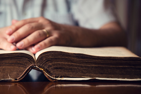 Male hands on 150 year old Bibleの写真素材