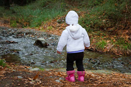 Ambitious Young Child Looking At The Stream Flowingの写真素材