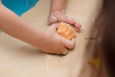 Little Hands Exploring The Beach Sand
