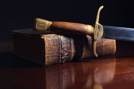 Ancient sword beside a 150 Year Old Bibleの写真素材