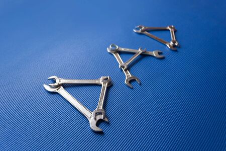 The word dad spelled out with wrenches on Blue background
