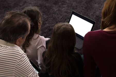 Family teaching children at home on Electronic Devices