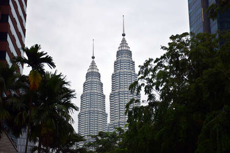 Kuala Lumpur, Malaysia, 08.14.2019: Spires of the Petronas Twin Towers with cloudy background during...