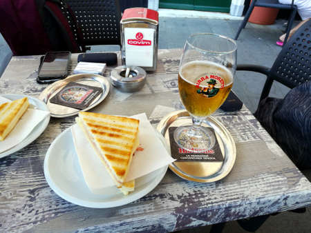Santa Margherita,Italy 06.30.2019: Sandwich and beer after a long sunny day on the Italian riviera Santa Margherita. It materializes like a calm Impressionist painting, It's a picture-perfect seaside promenadeのeditorial素材