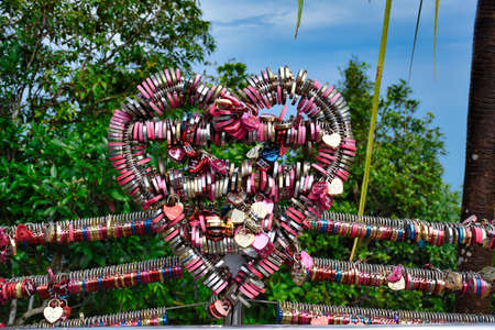Langkawi, Malaysia 12.08.2019: A love heart shaped statue full with locked love heart padlocks at...
