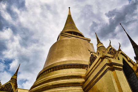 Characteristics of traditional Thai architecture created by artists who transform imagination to reality. Detailed, golden steeply-sloping tile roofs, up turned edges, open air spaces, lush gardensの写真素材