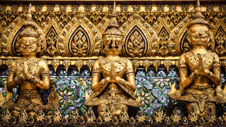 Characteristics of traditional Thai architecture created by artists who transform imagination to reality. Detailed, golden steeply-sloping tile roofs, up turned edges, open air spaces, lush gardensの写真素材