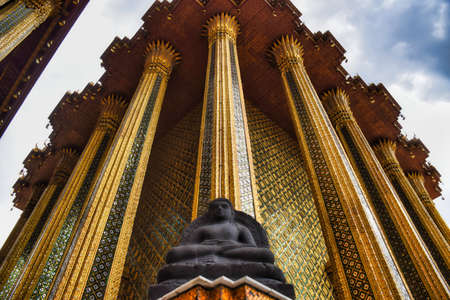 Characteristics of traditional Thai architecture created by artists who transform imagination to reality. Detailed, golden steeply-sloping tile roofs, up turned edges, open air spaces, lush gardensの写真素材