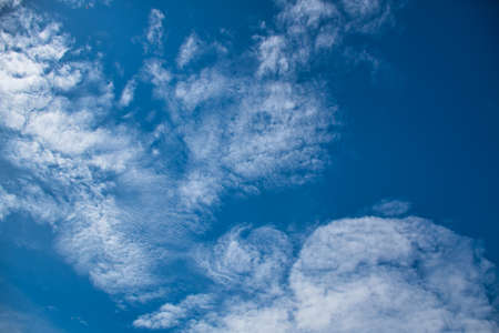 Beautiful blue sky with with light puffy cirrus clouds background textures