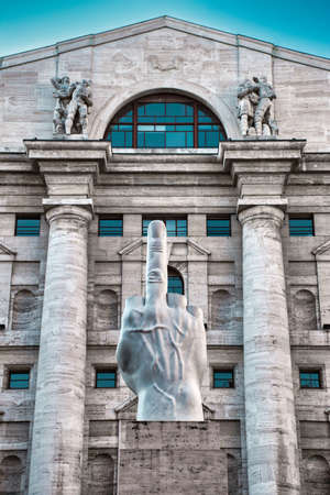 Milan, Italy 05.12.2020: L.O.V.E. marble statue by Maurizio Cattelan at Piazza Affari in Milan in front of the Italian stock exchange. Showcase of a hand with only its middle finger standing up.のeditorial素材