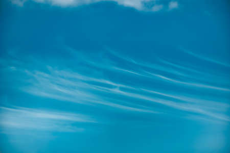 Beautiful blue sky with with light puffy clouds background textures