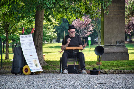 Milan, Italy 08.08.2020: A musician is playing music with a Theremin in Indro Montanelli Public Gardens, Giardini Pubblici Indro Montanelliのeditorial素材