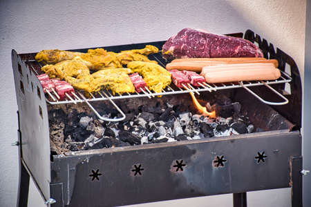 Assorted delicious to be grilled meat over the coals on barbecue