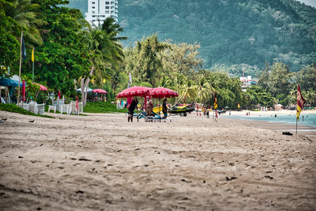 Phuket, Thailand April 19, 2021 Empty, calm sandy crescent Patong Beach with turquoise blue clear water and cirrus cloudy skyのeditorial素材