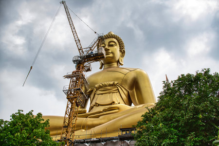 Bangkok Thailand April 07, 2021 Giant golden buddha statue of Dhammakaya Thep Mongkol Buddha in construction site located at Wat Paknam Bhasicharoen templeの写真素材
