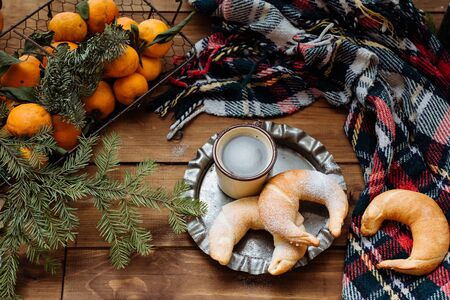 the cup of coffee and croissants on a window sill lies a plaid nearbyの写真素材