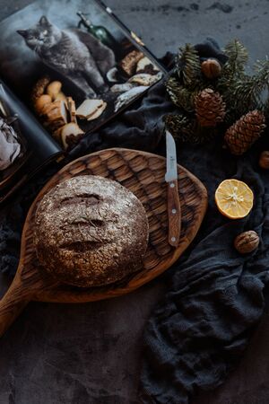 fresh loaf of bread and knife on beautifully decorated tableの写真素材