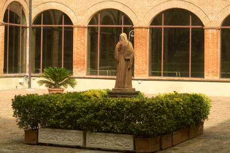 Abbey of Monte Oliveto Maggiore, Siena, Tuscany - Italy, March 7, 2019: Statue of Saint Benedict located at the center of cloisterのeditorial素材