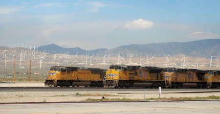 Mojave, South California, April-20-2019 - Inconsistencies in energy exploitation: Pollutants diesel drives vs wind plant that produces renewable energy.のeditorial素材