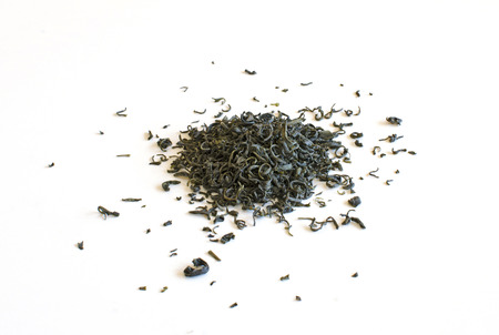 Spilled green tea leaves on a white backgroundの写真素材