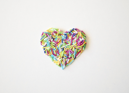 Close-up view of a texture Ripe sugar-coated rice in the shape of a heart isolated on a white backgroundの写真素材