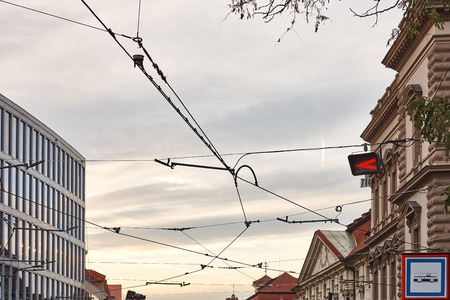 Power lines for trams and trolleybuses in the city between buildingsの写真素材