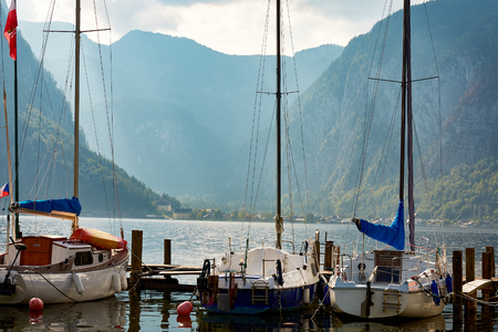 A view of Lake Hallstatt or the sea bay, yachts or sailing boats, mountain scenery and blue sky with cloudsのeditorial素材