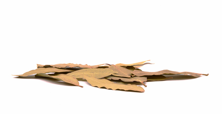 Close-up view of a pile of bay leaves. Spilled spices isolated on white background.の写真素材
