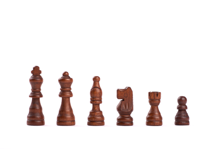 Set of black wooden chess figures standing in a row isolated on white backgroundの写真素材
