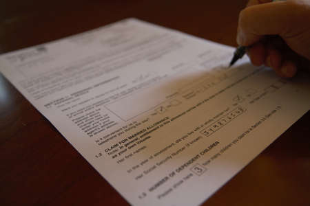 Hand filling out a tax formの写真素材