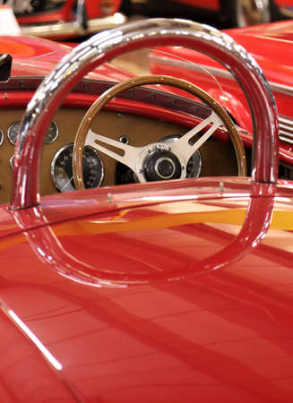 Classic sports car steering wheel through rear roll bar