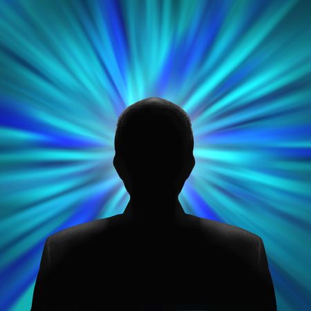 Black silhouette of a mysterious man in front of a blue vortexの写真素材