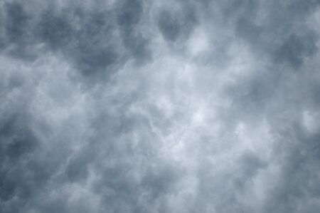 Dark clouds fill frame lighter toward centerの写真素材