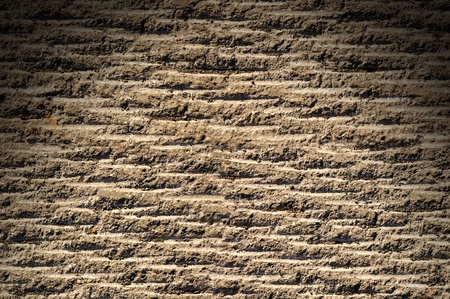 Grooved asphalt or rock surface texture lit from aboveの写真素材