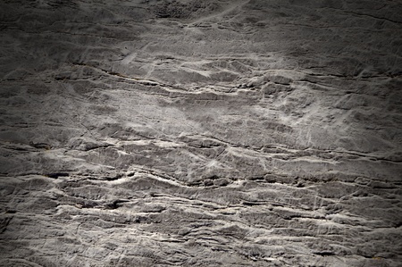 Cracked rock surface texture lit dramatically from aboveの写真素材