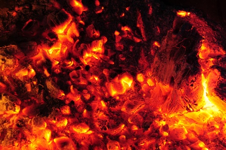 Burning embers in a molten fireの写真素材
