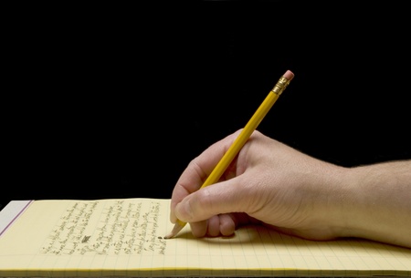 Handwriting with broken pencil point on yellow legal padの写真素材