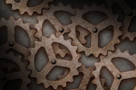 Distressed interlocking industrial metal gears lit diagonallyの写真素材