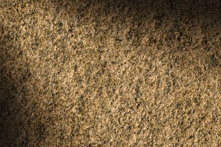 Granite rock stone background texture lit diagonallyの写真素材