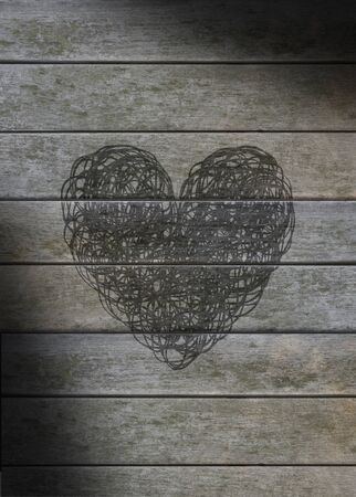 Heart scribbled on a gray weathered wood backgroundの写真素材