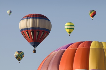 Hot-air balloons against a blue skyの写真素材