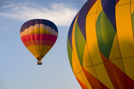 Multi-colored hot-air balloon with another in foregroundの写真素材