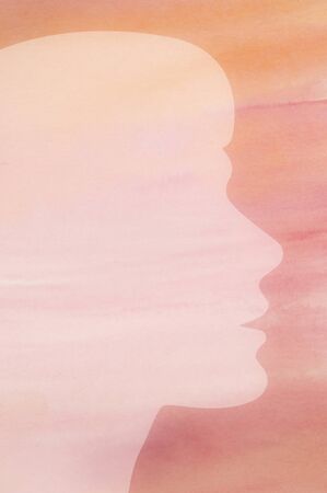 Female silhouette against a pink watercolor background textureの写真素材