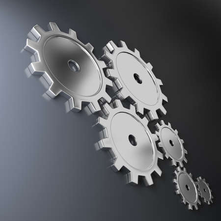 Metallic cog-wheels on a dark backgroundの写真素材