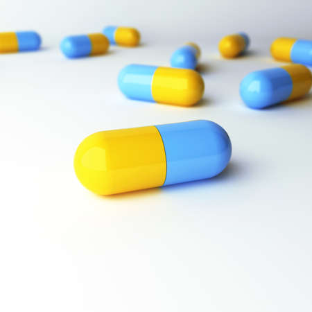 blue-yellow capsules with DOF on a white background