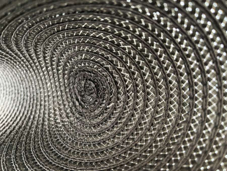 Grey colour background from circular wicker pattern texture.