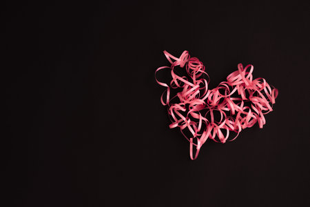 Heart made of ribbon. Pink curly heart.の写真素材