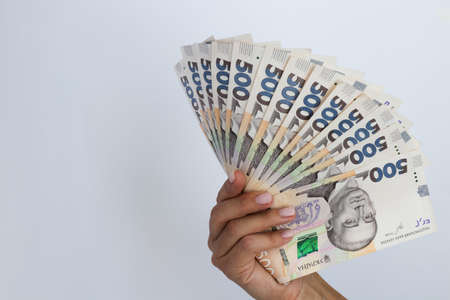 Ukrainian 500 hryvnia. 500 banknotes in a hand on a white background.の写真素材