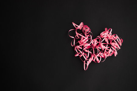 Heart made of pink ribbon. Pink curly heart.の写真素材