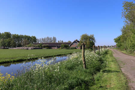 Countryside landscape in springtime. Farm near small river.の写真素材